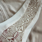 Close-up of a beige fabric with lace trim