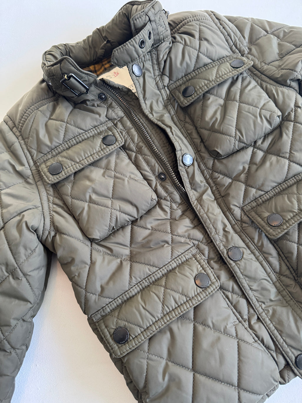 Quilted jacket with a zipper on a white background