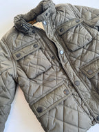 Quilted jacket with a zipper on a white background