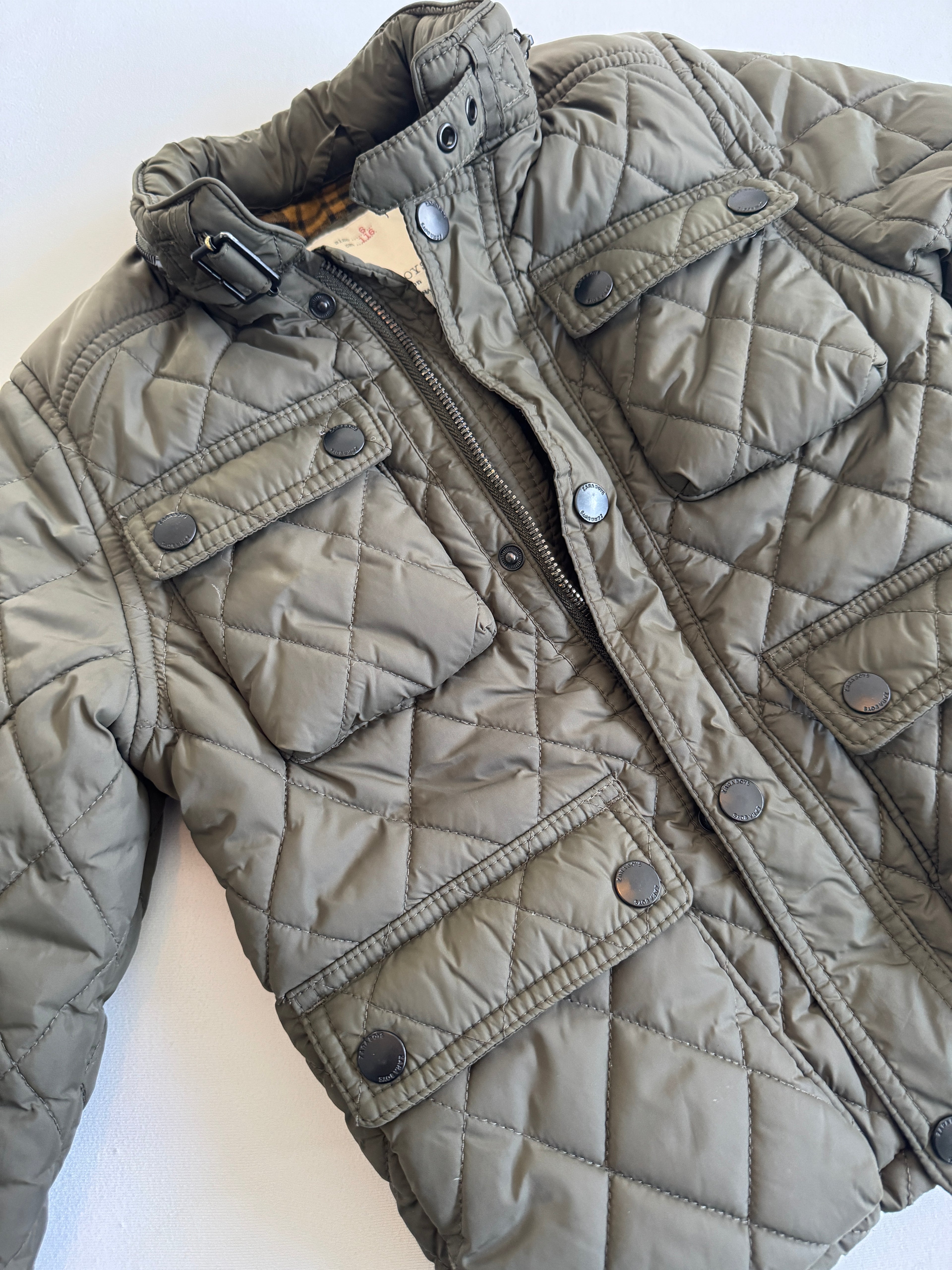 Quilted jacket with a zipper on a white background
