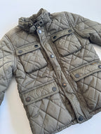 Quilted jacket with button details on a white background
