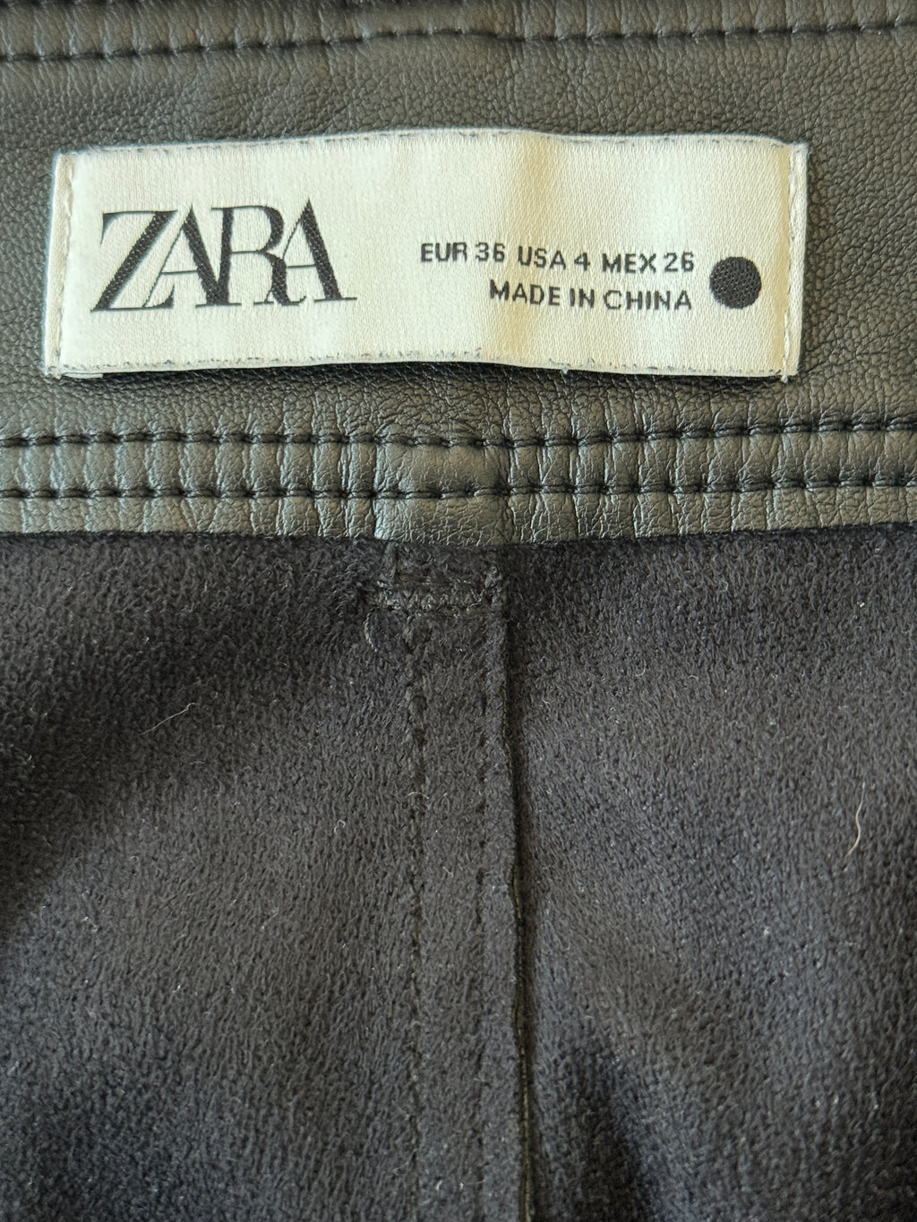 Zara label on a dark fabric background