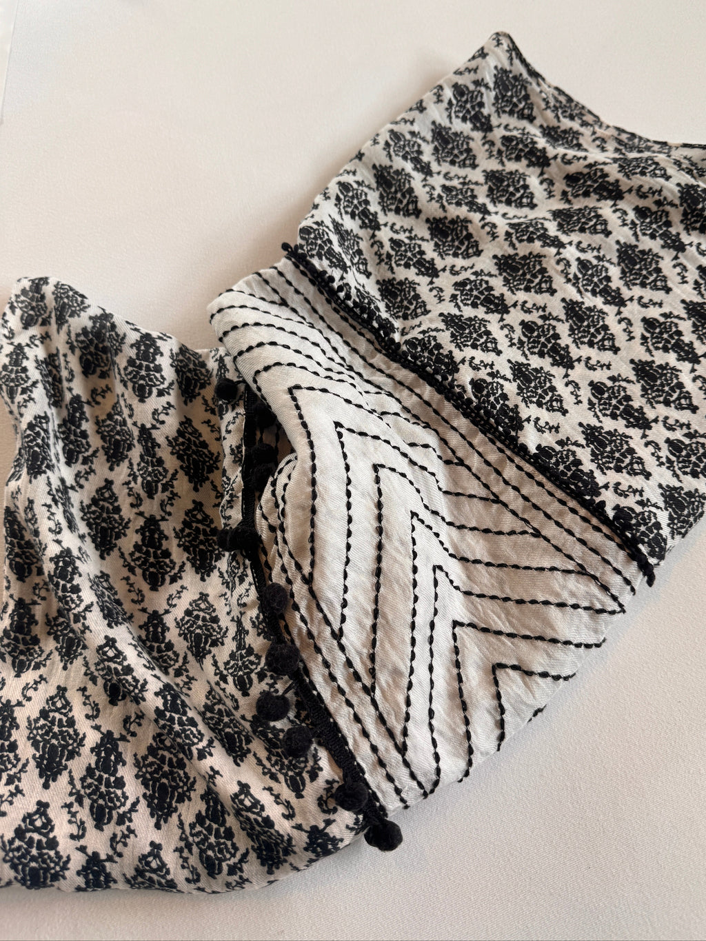 Black and white patterned fabric on a light background
