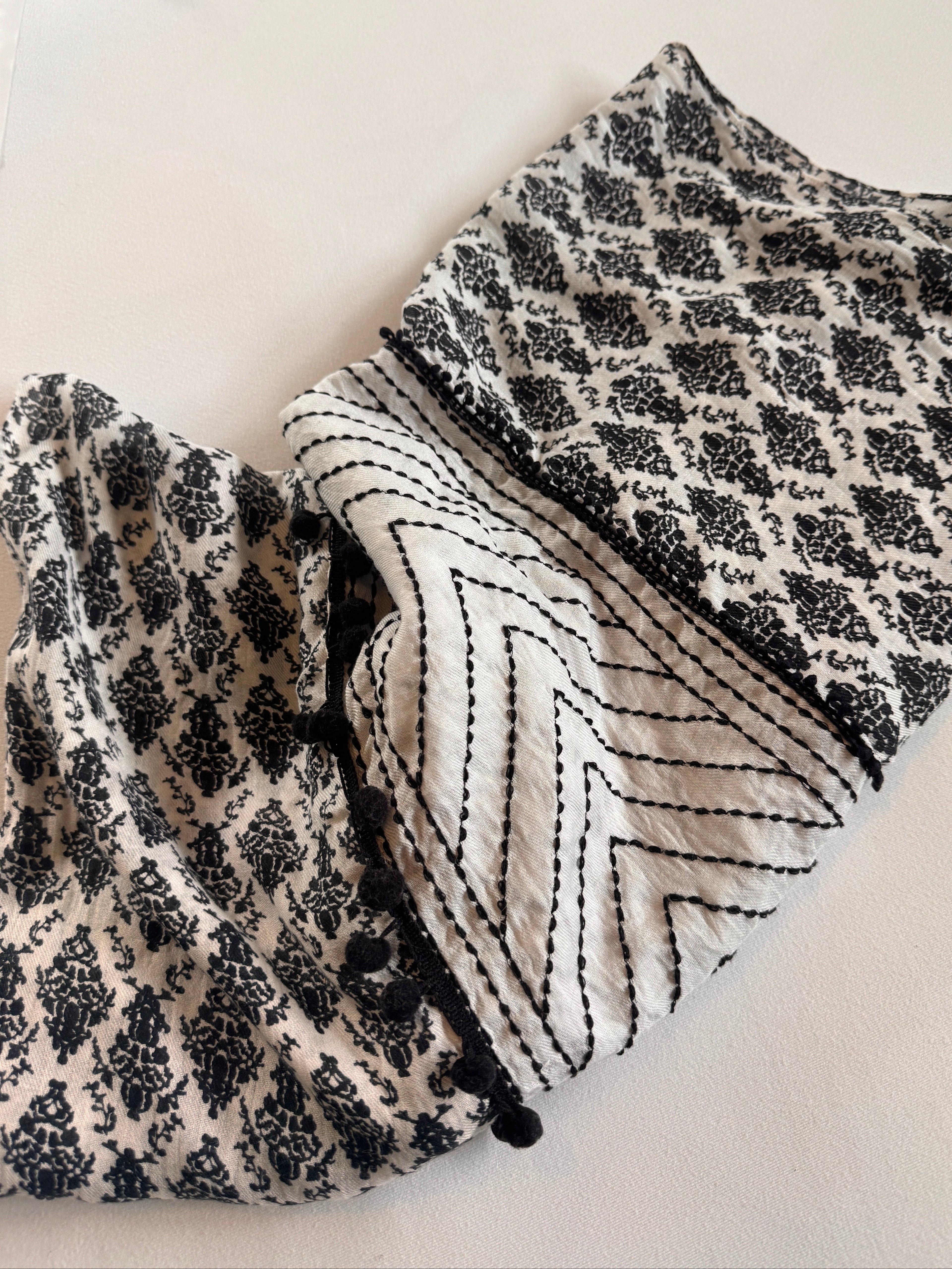 Black and white patterned fabric on a light background