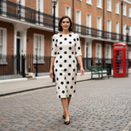 Woman in fitted Polka Dot Midi Dress walking in London