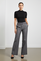 Woman in Plaid Wide-Leg Trousers with Black Mock Neck and Heels